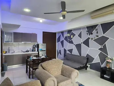 a living room with a couch and a table and a kitchen at Regalia Comfort Suites KLCC SkyPool in Kuala Lumpur