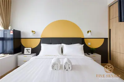 a bedroom with a white bed with white shoes on it at The Colony & The Luxe Signature Suites, KLCC in Kuala Lumpur
