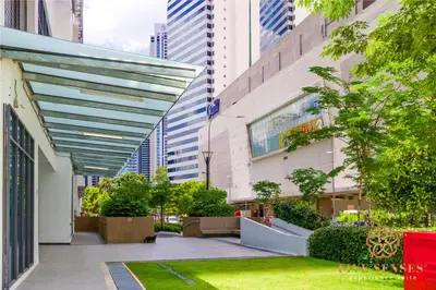 a courtyard in a city with tall buildings at The Colony & The Luxe Signature Suites, KLCC in Kuala Lumpur