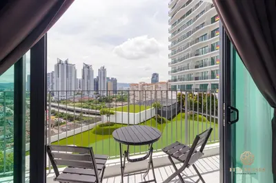 a balcony with a table and chairs and a view of a city at Datum Jelatek Residence, KLCC in Kuala Lumpur