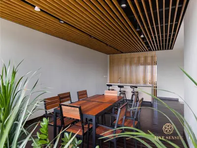 a dining room with a wooden table and chairs at Datum Jelatek Residence, KLCC in Kuala Lumpur