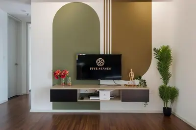 a living room with a television on a tv stand at UNA Signature Suites, Sunway KL in Kuala Lumpur