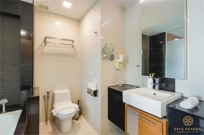 a bathroom with a white toilet and a sink at Dua Sentral Signature Suites in Kuala Lumpur