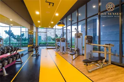 a gym with treadmills and machines in a building at Neu Suites Signature Suites, KLCC in Kuala Lumpur