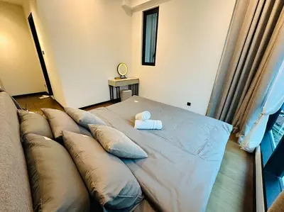 a bed with pillows and a teddy bear on it at Opus Residence KL 118 Chinatown by \u54c1\u5c4b PINWU Shortstay in Kuala Lumpur