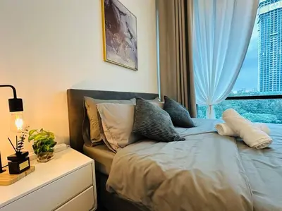 a bedroom with a bed and a window with a view at Opus Residence KL 118 Chinatown by \u54c1\u5c4b PINWU Shortstay in Kuala Lumpur