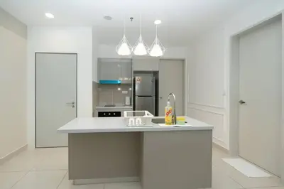 a white kitchen with a sink and a refrigerator at Cozy Skyline Retreat at Trion KL, Level 63 in Kuala Lumpur
