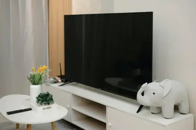 a living room with a tv and a elephant statue at Cozy Skyline Retreat at Trion KL, Level 63 in Kuala Lumpur