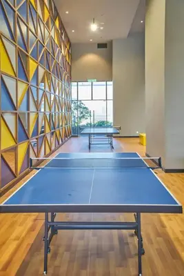 a ping pong table in a room with two tables at Cozy Skyline Retreat at Trion KL, Level 63 in Kuala Lumpur