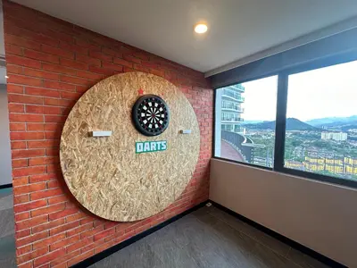 a wall with a dart board and a brick wall at Datum Jelatek Sky Resident KLCC by Deen in Kuala Lumpur