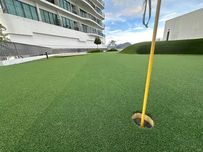 a yellow baseball bat on a green field at Datum Jelatek Sky Resident KLCC by Deen in Kuala Lumpur