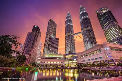 a city skyline with tall skyscrapers at sunset at Legasi Al Rahmat Kampung Baru in Kuala Lumpur
