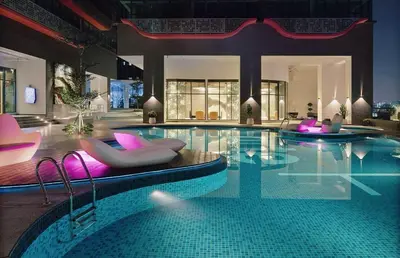 a large swimming pool with chairs and a swimming pool at Arte Plus Ampang KLCC City in Kuala Lumpur