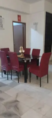 a dining room with a table and red chairs at EMPRESS SIGNATURE in Kuala Lumpur