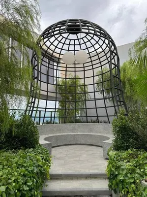 a large metal structure with stairs in a garden at Trion KL Family Condotel TRX KLCC MRT in Kuala Lumpur