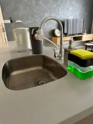 a kitchen sink with a faucet on a counter at Trion KL Family Condotel TRX KLCC MRT in Kuala Lumpur