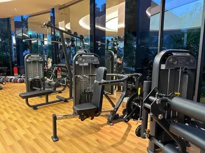 a gym with a row of treadmills and machines at Trion KL Family Condotel TRX KLCC MRT in Kuala Lumpur