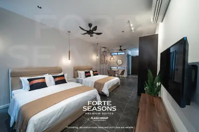a hotel room with two beds and a flat screen tv at Forte Seasons Scarletz Premium Suites @ KLCC in Kuala Lumpur