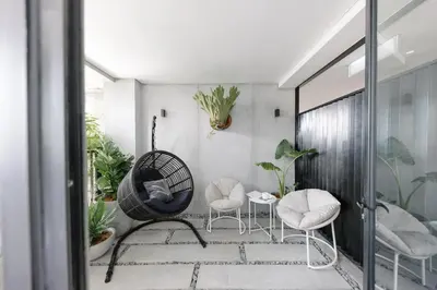 a room with two chairs and a swing at Lloyd's Inn Kuala Lumpur in Kuala Lumpur