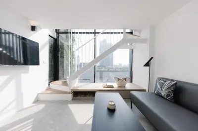 a living room with a couch and a large window at Lloyd's Inn Kuala Lumpur in Kuala Lumpur