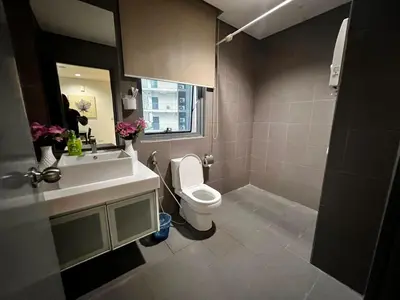 a bathroom with a toilet and a sink at Summer Suits Klcc by KL Residence in Kuala Lumpur
