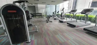 a gym with rows of treadmills and machines at Summer Suits Klcc by KL Residence in Kuala Lumpur