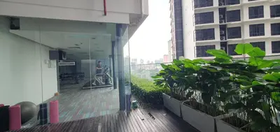 a person in a wheelchair on a balcony of a building at Summer Suits Klcc by KL Residence in Kuala Lumpur