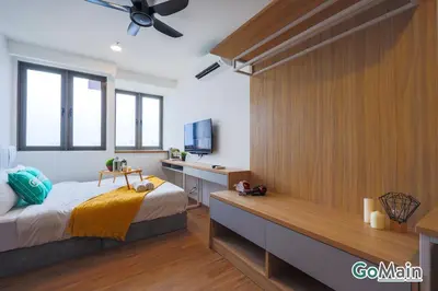 a bedroom with a bed and a desk and a television at Infinity SkyPool - KL Suite KL Sentral Brickfield by GoMain in Kuala Lumpur