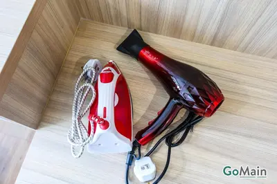 a blow dryer and a bottle of wine on a table at Infinity SkyPool - KL Suite KL Sentral Brickfield by GoMain in Kuala Lumpur