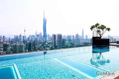a swimming pool with a view of the city at Infinity SkyPool - KL Suite KL Sentral Brickfield by GoMain in Kuala Lumpur