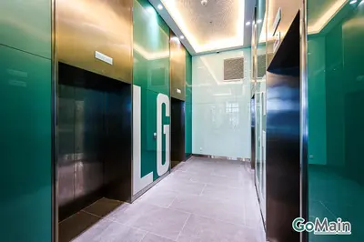a hallway with green walls and a tile floor at Infinity SkyPool - KL Suite KL Sentral Brickfield by GoMain in Kuala Lumpur