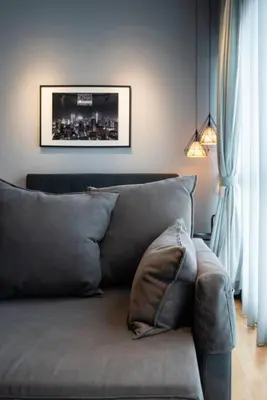 a couch in a living room with a picture on the wall at Modern Studio @ Kuala Lumpur, Regalia Residence in Kuala Lumpur