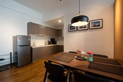 a kitchen with a dining room table and a refrigerator at Modern Studio @ Kuala Lumpur, Regalia Residence in Kuala Lumpur