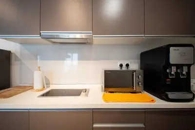 a kitchen counter with a toaster oven and a microwave at Modern Studio @ Kuala Lumpur, Regalia Residence in Kuala Lumpur