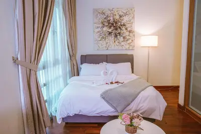 a bedroom with a bed with a flower on it at 6 PAX, Studio, 3mins to KLCC (3A01) in Kuala Lumpur