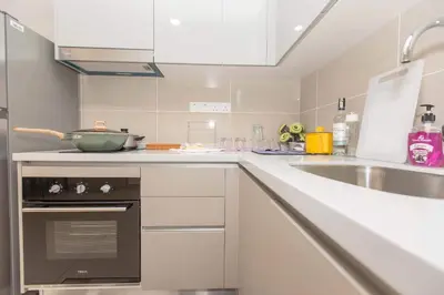 a white kitchen with a sink and a stove at Trion KL city centre near KLCC & TRX by MY TRIP & MY STAY in Kuala Lumpur