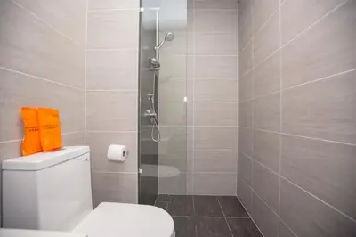 a bathroom with a toilet and a glass shower at Trion KL city centre near KLCC & TRX by MY TRIP & MY STAY in Kuala Lumpur