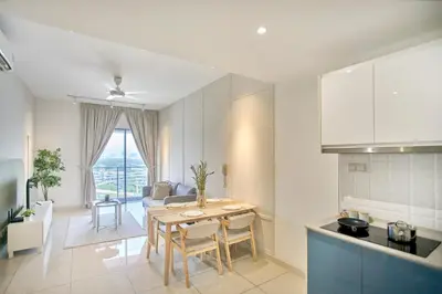 a kitchen and living room with a table and chairs at Continew Residence TRX KL in Kuala Lumpur