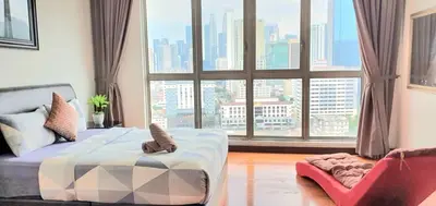 a room with a bed and a large window at Regalia Suites with Infinity Pool KLCC by Staycation Homes in Kuala Lumpur