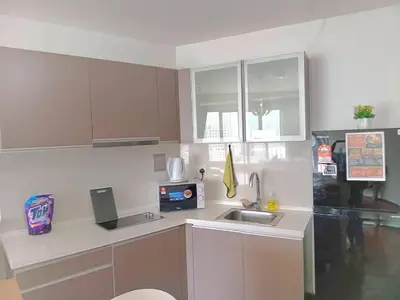 a white kitchen with a sink and a microwave at Regalia Suites with Infinity Pool KLCC by Staycation Homes in Kuala Lumpur
