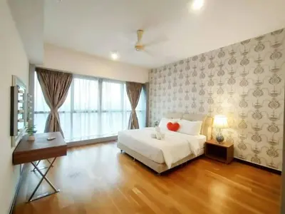 a bedroom with a bed and a desk and a window at Regalia Suites with Infinity Pool KLCC by Staycation Homes in Kuala Lumpur