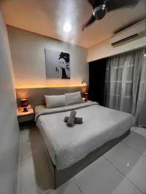 a bedroom with a bed with a teddy bear on it at Mercu summer Suites by KL Residence in Kuala Lumpur