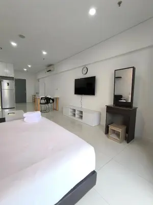 a white bedroom with a large bed and a tv at Mercu summer Suites by KL Residence in Kuala Lumpur