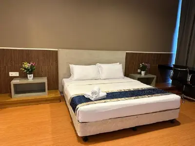 a bedroom with a large bed with white sheets at PLATINUM Suites KLCC By AR Hospitality in Kuala Lumpur