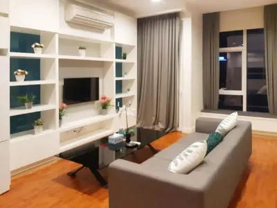 a living room with a couch and a piano at PLATINUM Suites KLCC By AR Hospitality in Kuala Lumpur