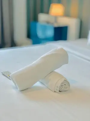 a roll of toilet paper sitting on top of a bed at PLATINUM Suites KLCC By AR Hospitality in Kuala Lumpur