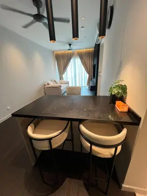 a kitchen with a black counter with chairs and a table at Datum Jelatek - KLCC Sky Ring Linked To LRT & Mall by AwNa in Kuala Lumpur