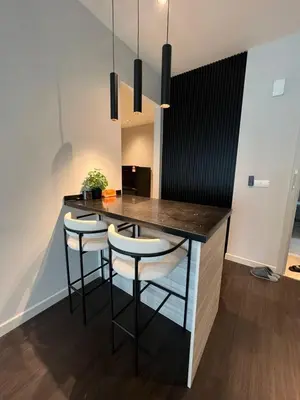 a kitchen with a bar with stools in a room at Datum Jelatek - KLCC Sky Ring Linked To LRT & Mall by AwNa in Kuala Lumpur