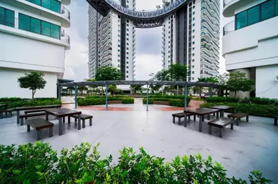 a group of tables and benches in front of a building at Datum Jelatek - KLCC Sky Ring Linked To LRT & Mall by AwNa in Kuala Lumpur