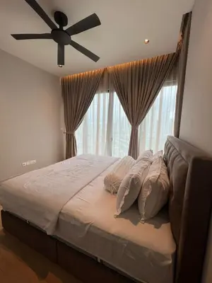 a bedroom with a large bed with a ceiling fan at Datum Jelatek - KLCC Sky Ring Linked To LRT & Mall by AwNa in Kuala Lumpur